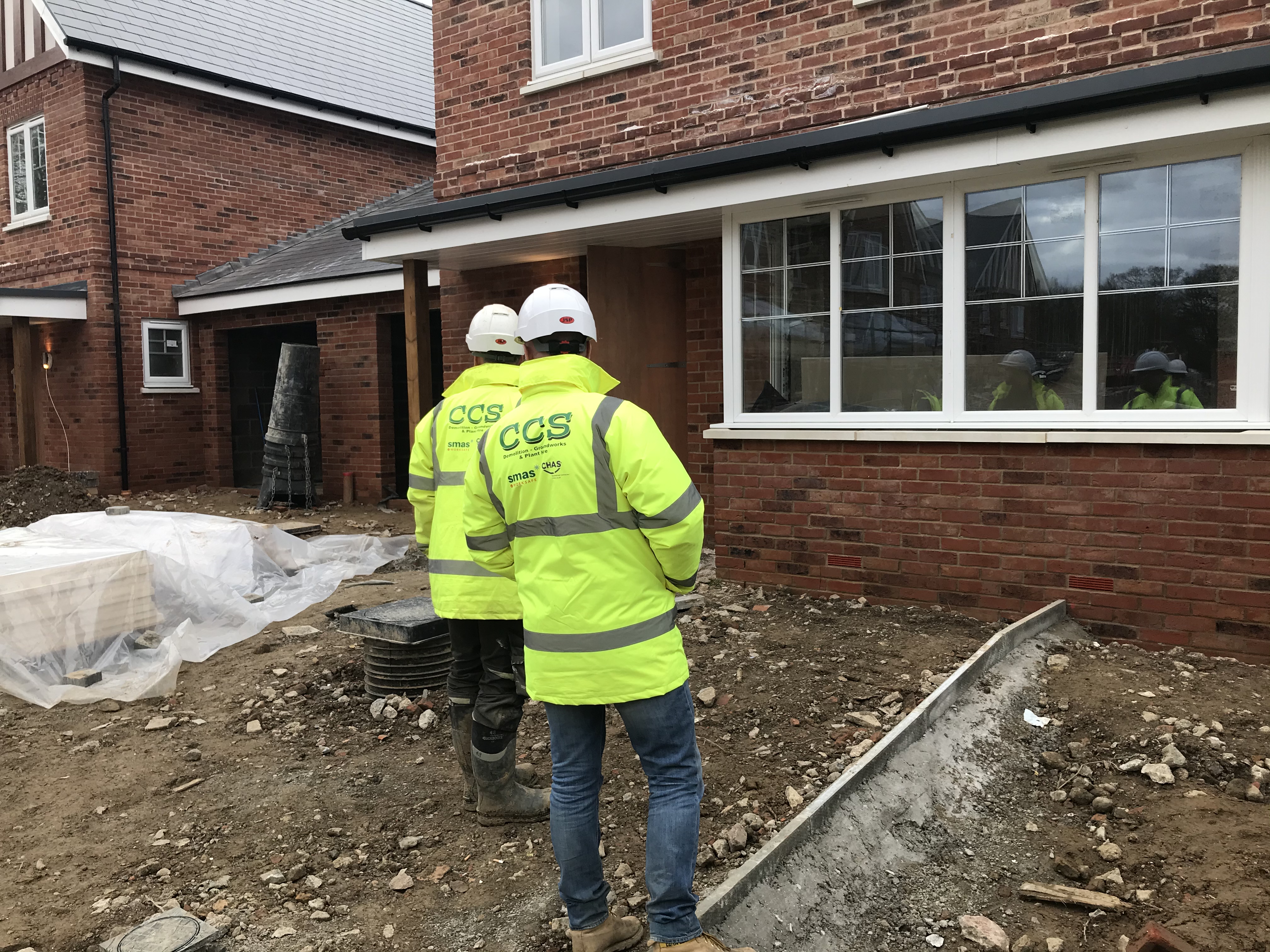 CCS Contractors Ltd site operatives in PPE hard hats completing health and safety checks.
